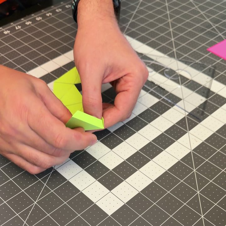Folding the scored template into a jewel shape.