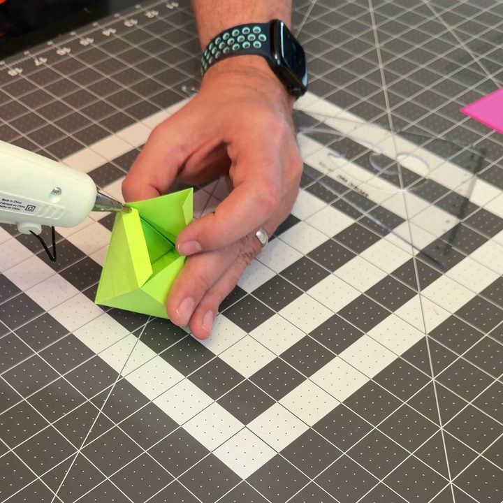 Gluing the last tabs of the jewel with a glue gun.